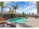 Sparkling pool surrounded by mature palm trees and lush landscaping creates a backyard oasis at 16351 W Central St, Surprise, AZ 85388