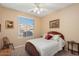 Cozy bedroom with window offering neighborhood views, complemented by a classic bed frame at 16351 W Central St, Surprise, AZ 85388