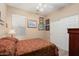 Comfortable bedroom with closet and window, complemented by a classic patterned bed frame at 16351 W Central St, Surprise, AZ 85388