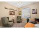 Cozy room featuring two plush armchairs, a ceiling fan, and natural light from a window at 16351 W Central St, Surprise, AZ 85388