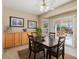 Charming dining room with dark wood table and chairs adjacent to sliding glass doors with pool view at 16351 W Central St, Surprise, AZ 85388