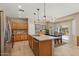 Bright kitchen featuring wood cabinets, stainless steel appliances, and an island with counter seating at 16351 W Central St, Surprise, AZ 85388