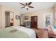 Light and airy main bedroom featuring wood floors, ceiling fan, and ensuite bathroom at 16351 W Central St, Surprise, AZ 85388