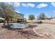 Spacious backyard with a covered patio, artificial grass, gravel, and a trampoline at 17190 W Bent Tree Dr, Surprise, AZ 85387