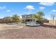 Expansive backyard with gravel landscaping, trampoline, patio, and a view of the two-story home at 17190 W Bent Tree Dr, Surprise, AZ 85387