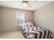 A cozy bedroom with a window and neutral-colored walls, perfect for relaxation at 17190 W Bent Tree Dr, Surprise, AZ 85387