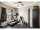 Home gym featuring a treadmill, weight rack, and ample space for exercise equipment at 17190 W Bent Tree Dr, Surprise, AZ 85387