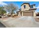 Charming two-story home with a well-maintained front yard, stone accents, and a two-car garage at 17190 W Bent Tree Dr, Surprise, AZ 85387