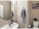 Well-appointed powder room with a stylish round mirror and decorative accents at 17190 W Bent Tree Dr, Surprise, AZ 85387