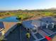 Elevated aerial view of home boasting desert landscaping, beautiful lake, and golf course at 17721 E Bismark Lake Ct, Rio Verde, AZ 85263