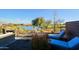 Relaxing patio area overlooking a serene lake and golf course, with lounge chairs at 17721 E Bismark Lake Ct, Rio Verde, AZ 85263