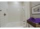 Bathroom showing decorative tile, shower-tub, and purple hand towels hanging on towel bar next to framed artwork at 17721 E Bismark Lake Ct, Rio Verde, AZ 85263