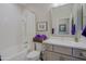 Bright bathroom with decorative tile, shower-tub, and vanity with drawers and a large framed mirror at 17721 E Bismark Lake Ct, Rio Verde, AZ 85263