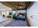 Cozy patio area featuring a daybed, ceiling fan, and seamless indoor-outdoor flow to the living room at 17721 E Bismark Lake Ct, Rio Verde, AZ 85263