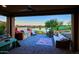 Inviting covered patio with BBQ, ample seating, and serene views of the lake and golf course at 17721 E Bismark Lake Ct, Rio Verde, AZ 85263