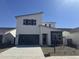 Contemporary two-story home with a sleek design, featuring a modern garage door and neutral color palette at 17957 W Long Lake Rd, Goodyear, AZ 85338