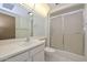 Functional bathroom featuring a single sink vanity, toilet, and a shower stall with sliding glass doors at 18034 N Highwood Ct, Sun City, AZ 85373