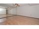 Bedroom with hardwood floors and a large mirrored wall at 18034 N Highwood Ct, Sun City, AZ 85373