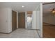 Well-lit entryway with a mirrored wall, tile flooring, and a decorative glass door insert at 18034 N Highwood Ct, Sun City, AZ 85373