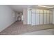 Spacious garage with ample storage cabinets along one wall and access to the laundry area and the rest of the house at 18034 N Highwood Ct, Sun City, AZ 85373