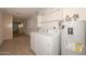 Bright laundry room features a washer, dryer, and water heater, with lots of room for storage and cleaning at 18034 N Highwood Ct, Sun City, AZ 85373