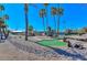 Fun mini golf course with palm trees and various obstacles, perfect for Gathering entertainment at 18034 N Highwood Ct, Sun City, AZ 85373