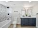 Bathroom featuring a tub with shower, double vanity and modern black fixtures at 1913 E 1St Ave, Mesa, AZ 85204