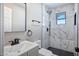 Updated bathroom with marble tile, black fixtures, and modern vanity at 1913 E 1St Ave, Mesa, AZ 85204