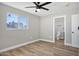 Bedroom with wood floors, ceiling fan, and ensuite bathroom access at 1913 E 1St Ave, Mesa, AZ 85204