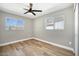 Bedroom featuring wood floors, ceiling fan and two large windows at 1913 E 1St Ave, Mesa, AZ 85204