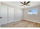 Bright bedroom with ceiling fan, wood flooring, and sliding closet doors at 1913 E 1St Ave, Mesa, AZ 85204