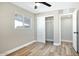 Bright bedroom features modern ceiling fan, closet, and a window offering plenty of natural light at 1913 E 1St Ave, Mesa, AZ 85204