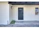 Inviting front entrance with a stylish black door and well-maintained exterior, surrounded by rocks at 1913 E 1St Ave, Mesa, AZ 85204