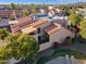 Lovely rear view of stucco townhome with private patio, red tile roof and attractive southwestern landscaping at 1920 E Maryland Ave # 16, Phoenix, AZ 85016