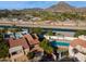 Stunning aerial view of a home featuring a sparkling pool, lush landscaping, and beautiful mountain views at 1920 E Maryland Ave # 16, Phoenix, AZ 85016