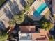 Aerial view of a home boasting a swimming pool, patio, lush greenery, and a well-maintained tile roof at 1920 E Maryland Ave # 16, Phoenix, AZ 85016