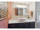 Bathroom featuring a modern sink, a gold mirror, a neutral color scheme, and white countertops at 1920 E Maryland Ave # 16, Phoenix, AZ 85016