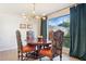 Dining area with stylish chairs, modern chandelier, and natural lighting from an outdoor view at 1920 E Maryland Ave # 16, Phoenix, AZ 85016