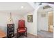 Bright hallway with sitting area featuring a chair and carpet flooring; a great space for relaxing and reading at 1920 E Maryland Ave # 16, Phoenix, AZ 85016