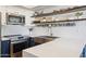 Beautiful kitchen featuring stainless steel appliances, white countertops, farmhouse sink and open wooden shelving at 1920 E Maryland Ave # 16, Phoenix, AZ 85016