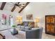 Comfortable living room with exposed beam ceiling, modern furnishings, and a glass coffee table at 1920 E Maryland Ave # 16, Phoenix, AZ 85016