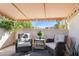 Cozy covered patio with comfortable seating and views of the surrounding landscape at 1920 E Maryland Ave # 16, Phoenix, AZ 85016