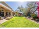 A verdant backyard with a covered patio, a fire pit, a pergola, and lush landscaping for relaxed outdoor living at 22970 N 79Th Pl, Scottsdale, AZ 85255