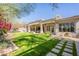 Expansive backyard with lush lawn, patio, and privacy landscaping at 22970 N 79Th Pl, Scottsdale, AZ 85255