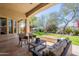 Inviting patio area with comfortable seating, a coffee table, and a scenic view of lush landscaping at 22970 N 79Th Pl, Scottsdale, AZ 85255