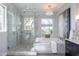 Bathroom with a marble soaking tub, glass shower enclosure, and dark wood cabinets at 22970 N 79Th Pl, Scottsdale, AZ 85255