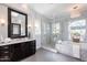 Bright bathroom with a glass enclosed shower, soaking tub, and dual sink vanity with a large mirror at 22970 N 79Th Pl, Scottsdale, AZ 85255