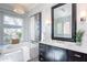 Bathroom features a marble tub, large mirror, dark wood cabinets, and decorative lighting at 22970 N 79Th Pl, Scottsdale, AZ 85255