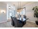 Bright dining room featuring wood floors, elegant lighting, and neutral paint at 22970 N 79Th Pl, Scottsdale, AZ 85255