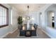 Spacious dining area with view into hall, neutral paint, modern lighting and wood floors at 22970 N 79Th Pl, Scottsdale, AZ 85255